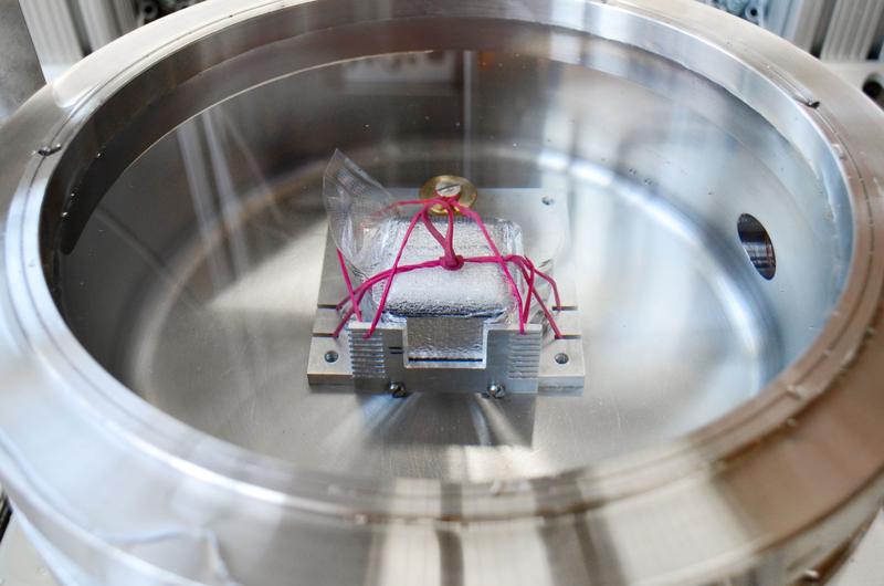 Pressure chamber for hydrostatic compression test with the vacuum packed specimen fixed with elastic bands