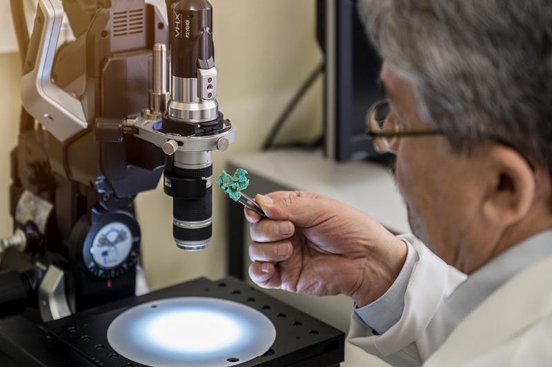 Prof. Hermann Ehrlich looks at a piece of the new material.