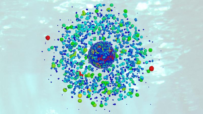 Grafische Darstellung eines zerplatzenden Goldnanopartikels, der per Ultra-Kurzzeit-Laser angeregt wurde. Die Farben geben die Größen der entstehenden Fragmente wieder: rund 3 nm (rot), rund 1 nm (blau).