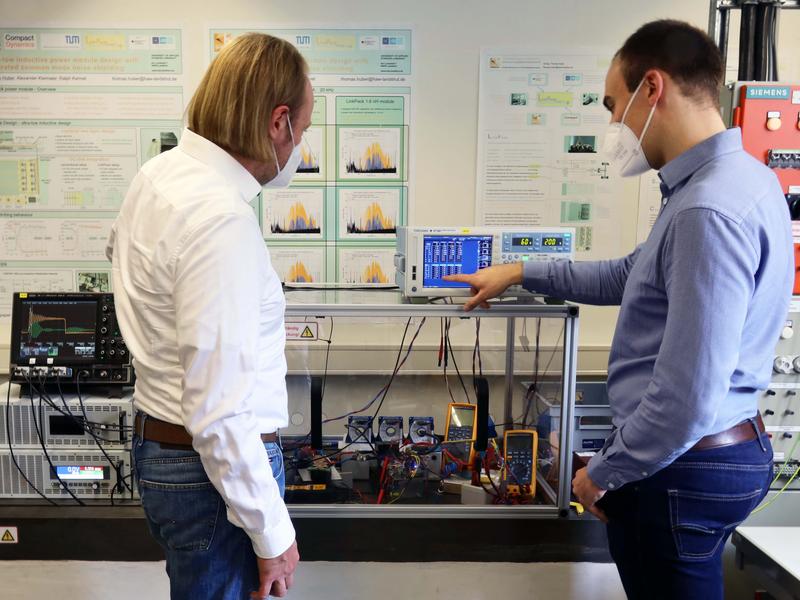 Research assistants Janusz Wituski (left) and Thomas Huber (right) at the high-voltage test set-up