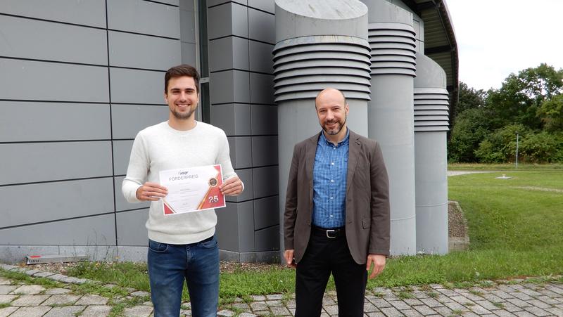 The award-winning computer scientist Martin Sträßer and Professor Samuel Kounev with the certificate awarded for the outstanding Master's thesis.