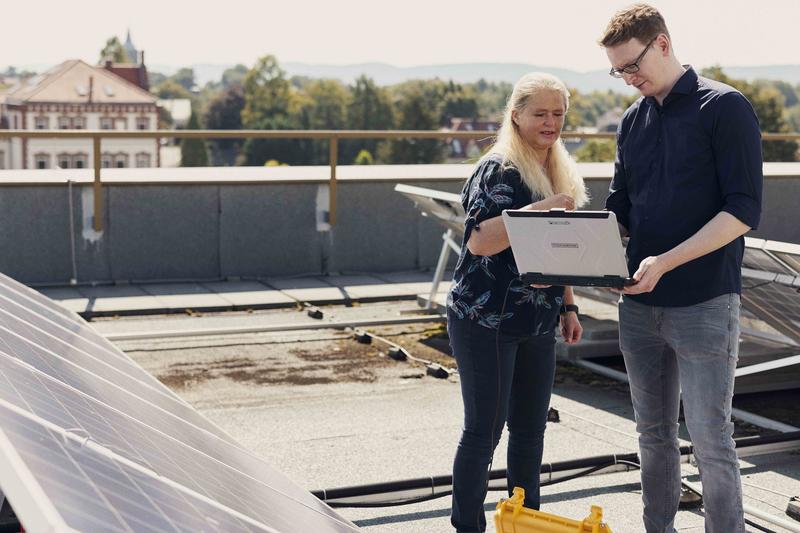 Prof. Dr. Grit Behrens und Felix Meyer messen Kennlinien an der Photovoltaikanlage auf dem Dach des Gebäudes D auf dem Campus Minden der FH Bielefeld.