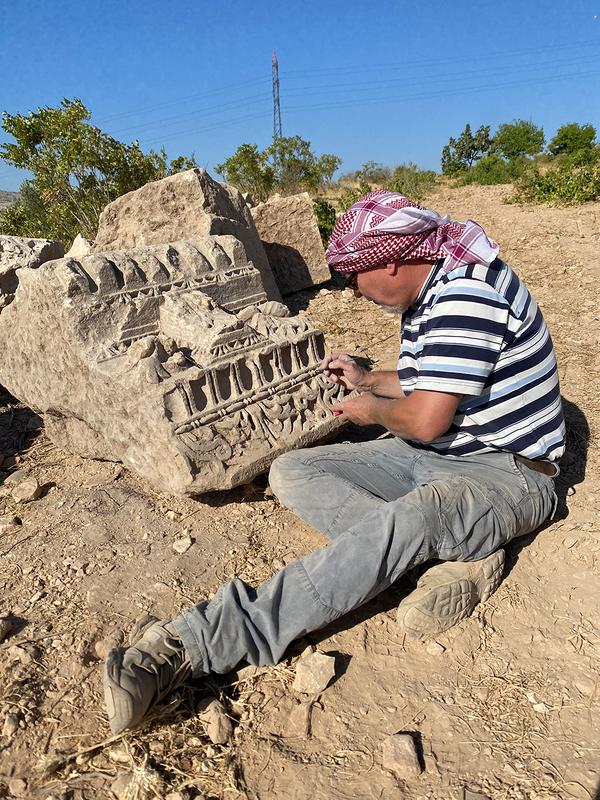 Examining part of the temple’s entablature