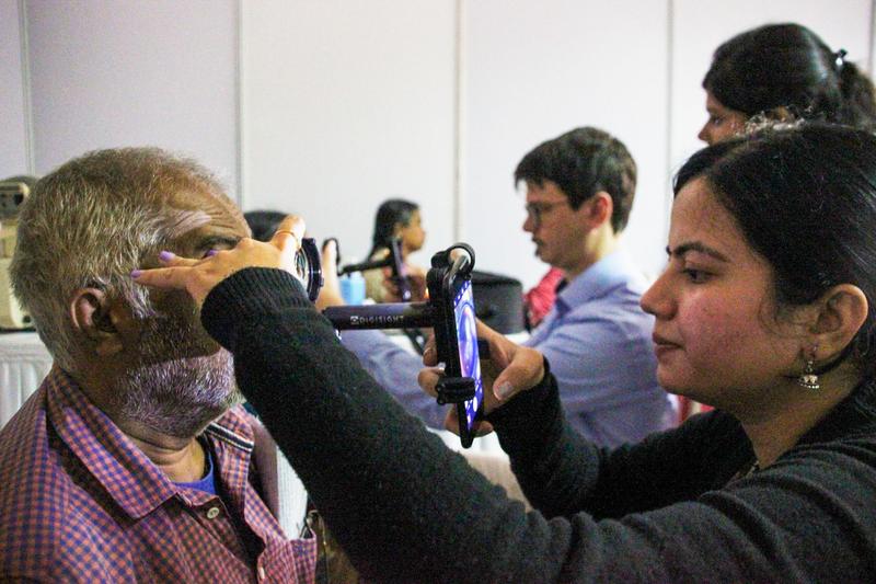 Smartphone-based, telemedical DR-Screening Program in India: Together with trained ophthalmic assistant from the Sankara Eye Foudation India, Dr. Maximilian Wintergerst (in the middle in the background) examines patients for DR using adapted smartphones