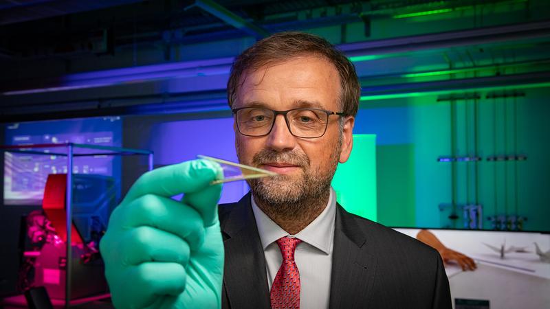 Prof. Dr. Oliver G. Schmidt is a pioneer in the exploration and development of extremely small, shapeable and flexible microrobotics. The photo shows him with an ultra-flexible microelectronic foil between his fingers. 