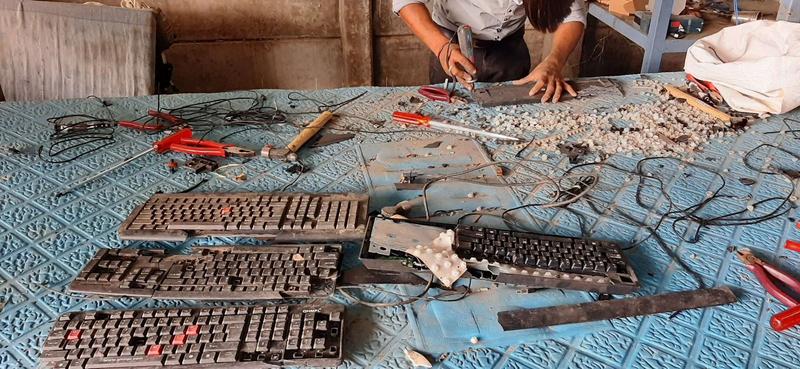 Dismantling keyboards. In India, more than 90% of e-waste is handled by the informal sector.