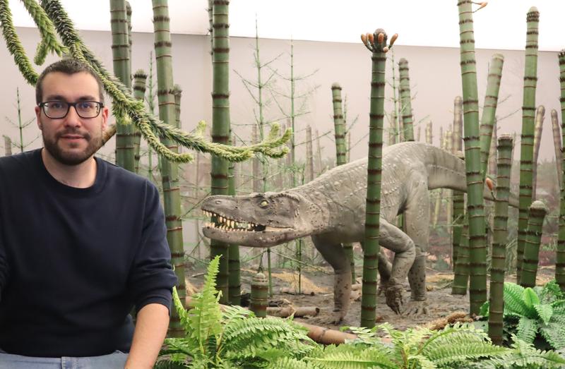 Dr. Eudald Mujal Grané in front of a reconstruction of the habitat of Batrachotomus.