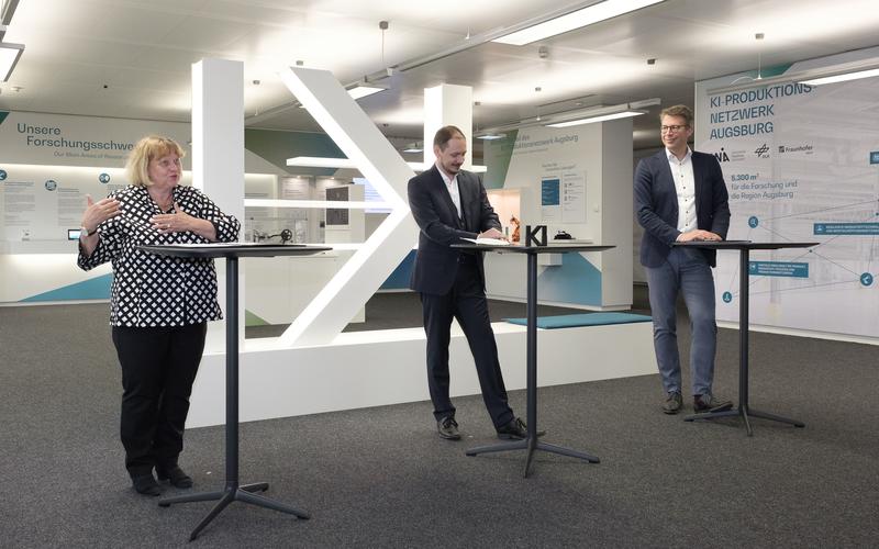 Universitätspräsidentin Prof. Dr. Sabine Doering-Manteuffel, KI-Produkionsnetzwerk-Direktor Prof. Dr. Markus Sause und Wissenschaftsminister Markus Blume eröffnen den Showroom für KI in der Produktion 