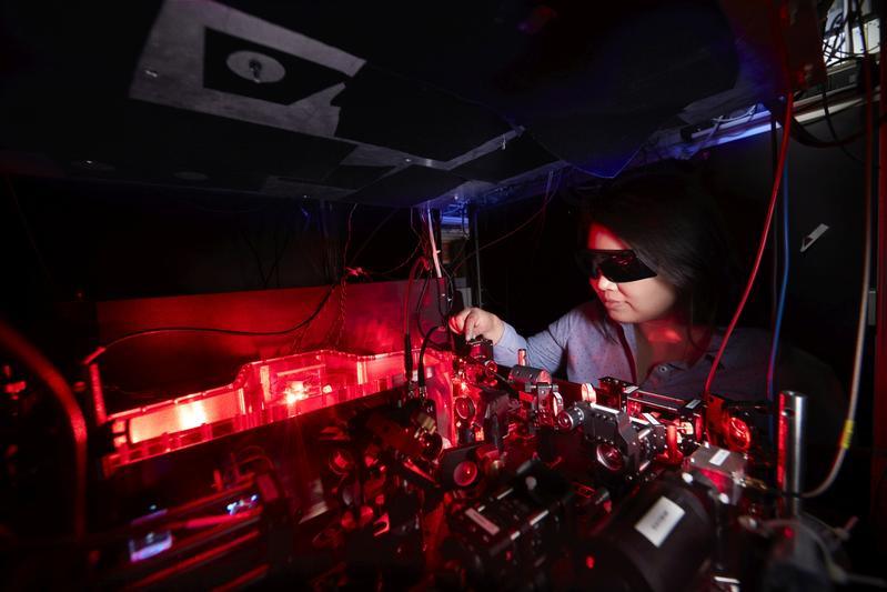 Dr Pimonpan Sompet (first author of the paper) aligning the second-harmonic generation cavity. The researchers use the UV light produced in here to cool the lithium atoms in the experiment.