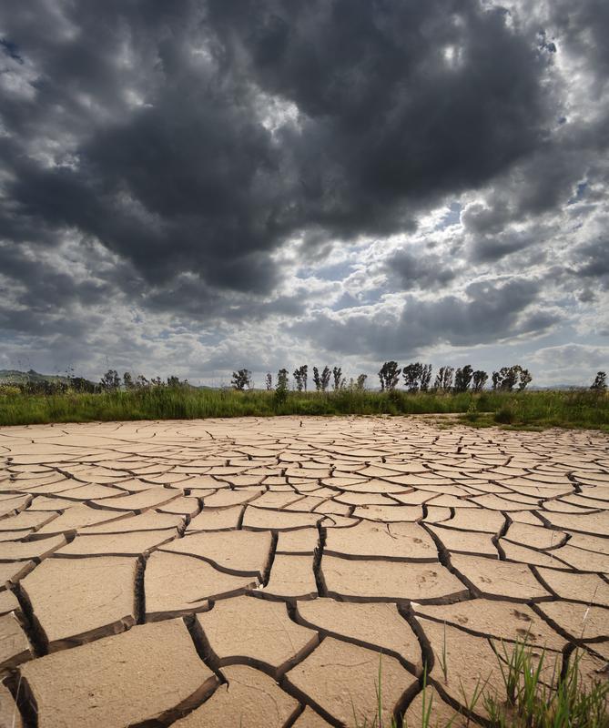 Stormy clouds and withered land