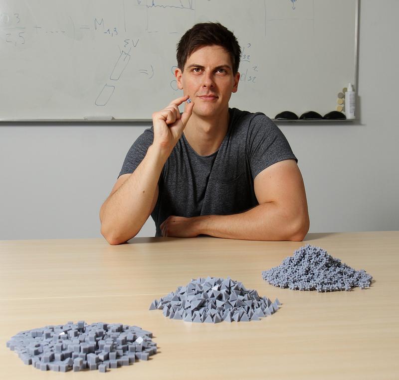Robert Hesse shows the 3D-printed non-spherical particles he used to validate the simulation models in the project.