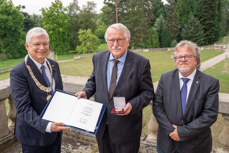 Ministerialdirigent a. D. Joachim Hauck (m.) erhält von Rektor Prof. Dr. Stephan Dabbert (l.) die Universitätsmedaille in Gold. Rechts: Prof. Dr. Ralf Vögele, Dekan der Fakultät Agrarwissenschaften.