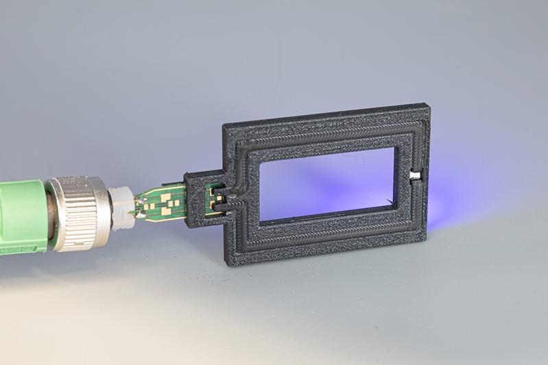 LED demonstrator with integrated circuit board, printed TPE track, contacted LED and insulating PBT housing.