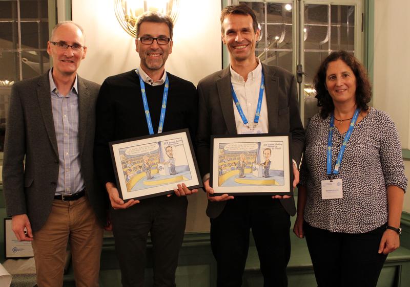 ACP co-chief executive editors Ken Carslaw and Barbara Ervens (left, right) with Thomas Koop and Uli Pöschl (center left, center right) who received a cartoon commemorating intense discussions at the first ACP editorial board meeting. 