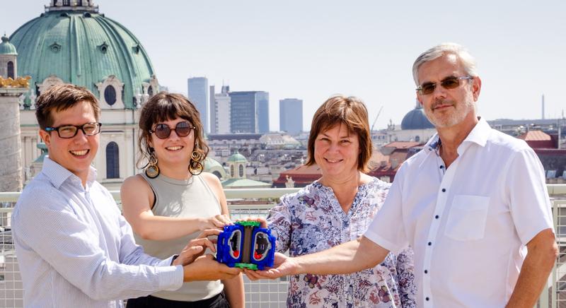 from left to right: Georg Harrer (TU Wien), Lidija Radovanovic (TU Wien), Elisabeth Wolfrum (IPP Garching), Friedrich Aumayr (TU Wien) holding a 3D printed 1:100 model of ITER