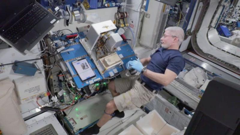 Astronaut on the International Space Station ISS assembling the components.