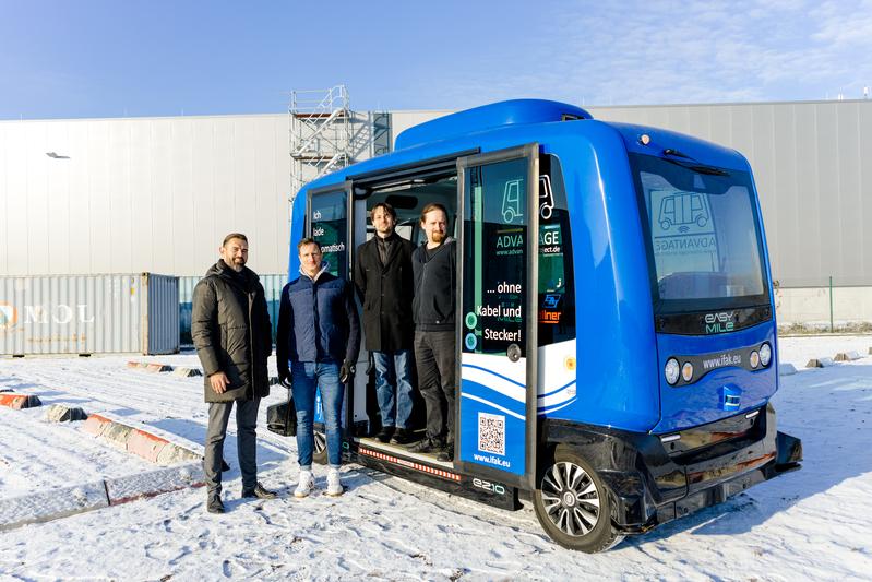 Dr. Maxim Nesterov und M.Eng. Bastian Rappholz vom Projektteam AULA-KI des ifak e.V. sowie Dr. Christoph Steup und M.Sc. Dominik Weikert vom Projektteam AULA-KI der Uni Magdeburg (v.li.n.re.) mit dem EsayMile Shuttle auf dem Galileo-Testfeld.