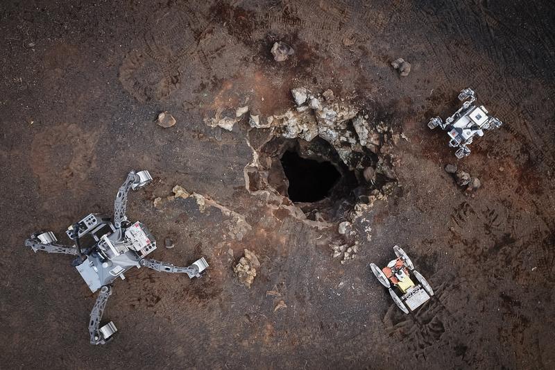 The DFKI rovers SherpaTT (left) and Coyote III (center) and LUVMI-X from Space Applications Services NV/SA (right) from a drone perspective. 