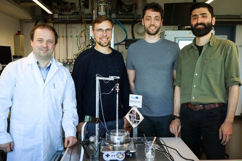 Members of the "Model Experiments" group in their lab at IKZ with a prototype of the demonstration crystal growth setup. From left to right: Kaspars Dadzis, Arved Wintzer, Iason Tsiapkinis, Sepehr Foroushani. 