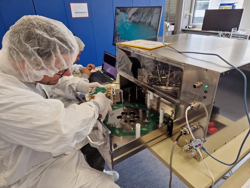 Einbau des Experimentblocks in das FLUMIAS-ISS-Rack. Der Block enthält das Untersuchungsobjekt (hier: Mammakarzinomzellen) und ein Lebenserhaltungssystem für die Zellen. Das Mikroskop befindet sich auf der Zentrifuge im Rack. 