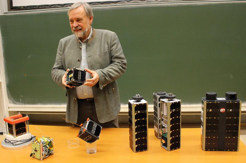 Klaus Schilling with some of the small satellites developed by his team together with students. 