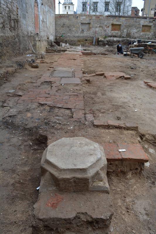 Overview of the excavation area with partially preserved church floor, column bases and grave slabs.
