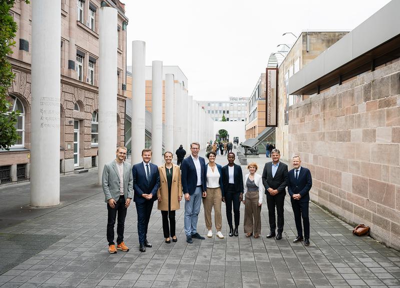 Jakob Nehls (FAU), Nürnbergs OB Marcus König, Dr. Janina Heaphy (FAU), Wissenschaftsminister Markus Blume, Prof. Dr. Anuscheh Farahat, Aneth Lwakatare-Thumm (FAU), Janina Stürner (alle FAU), FAU-Präsident Prof. Joachim Hornegger, Prof. Michael Krennerich.