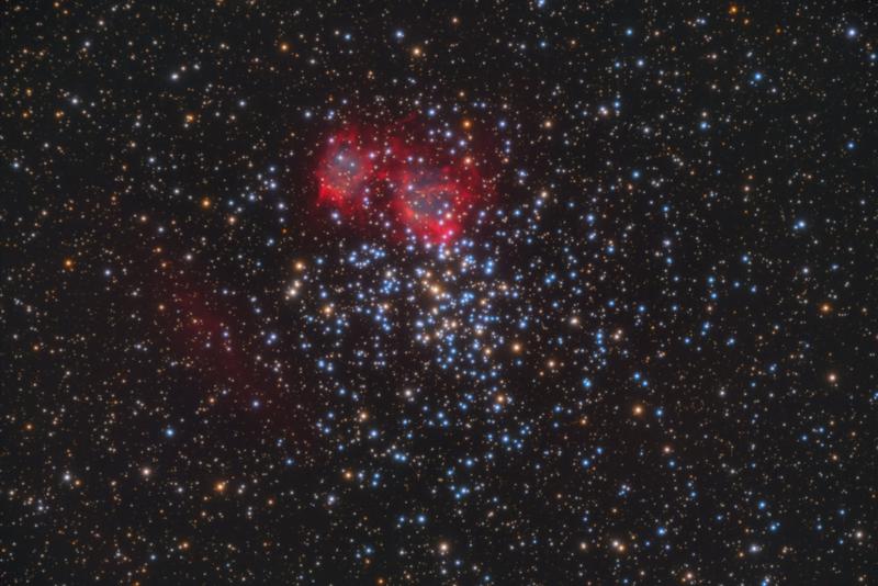 Image of the planetary nebula in the open star cluster Messier 37. The cluster contains several hundred stars. The butterfly-shaped nebula is visible due to red luminous hydrogen gas.