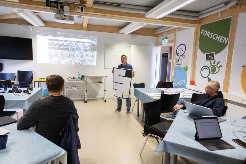 Prof. Jürgen Tchorz vom JuniorCampus der TH Lübeck zeigt das Labyrinth, durch das die Schüler*innen den Roboter steuern sollen. 