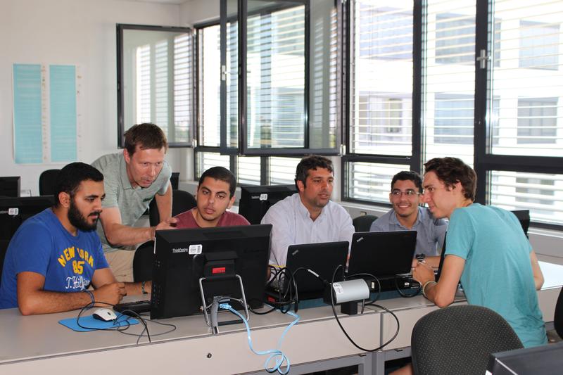 Arbeitssituation: Studierende der Informatik der DHBW Karlsruhe mit Lehrenden an Computern