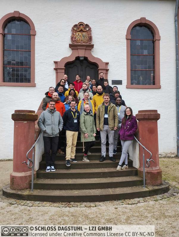 Participants of Dagstuhl Seminar 24082 - "AI for Social Good" in front of Dagstuhl manor's chapel.