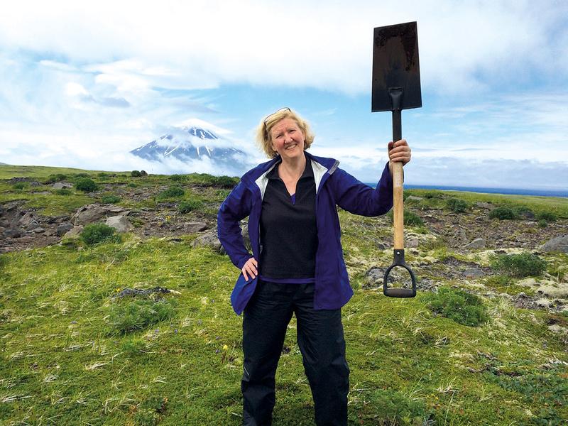 Geoscientist Dr Terry Plank in front of Mount Carlisle in the Aleutian Island Arc during field work to collect samples from explosive volcanic deposits. 