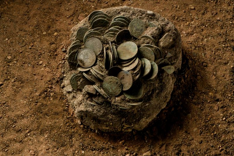 The coin hoard recovered in a sediment block.