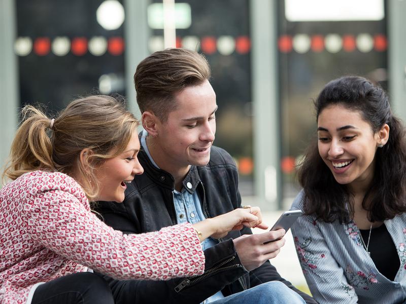 Researchers look at the Welcome Guide via smartphone.