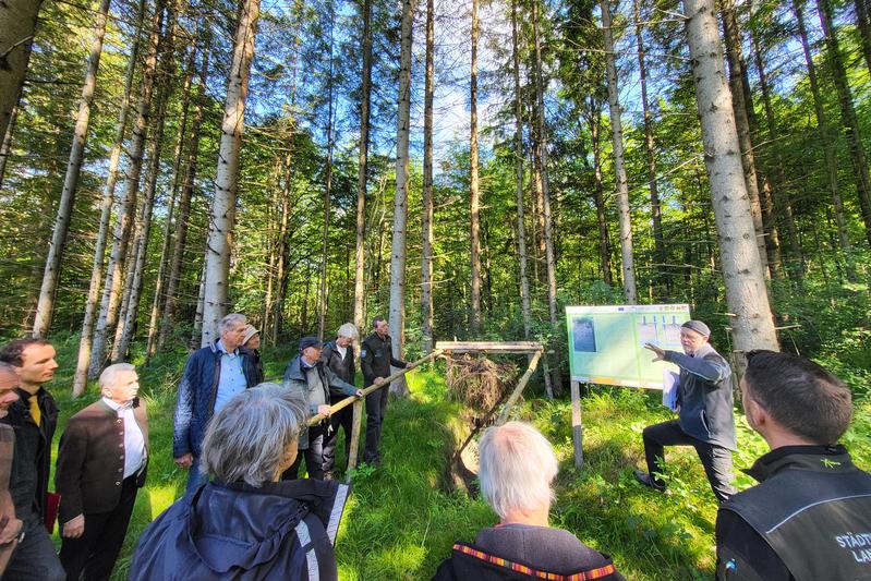 Ludwig Pertl, Gewinner des Sonderpreises "Nachhaltigkeit Wald" im Rahmen des Deutschen Waldpreises 2021, erläutert an einem Profil am Bodenlehrpfad im Gemeindewald Scheuring den Waldumbau mit Fokus auf lebendigen Boden.