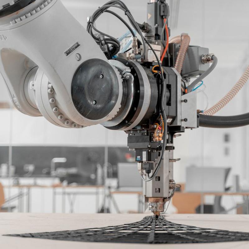 Large-scale additive manufacturing platform for robotic material programming.