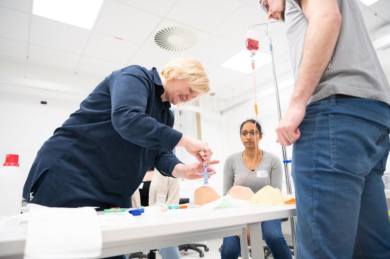 Interprofessional training on a model: nursing staff practise bone marrow puncture on a simulator to change their perspective.