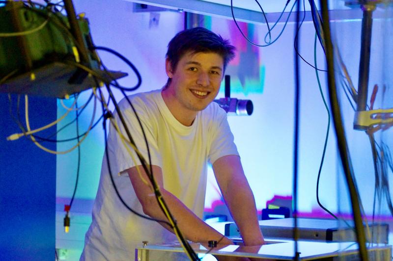 Doktorand Alexander Jäckel untersucht im Labor mit Terahertz-Wellen die Struktur und die elektrischen Eigenschaften von dünnen leitfähigen Schichten auf Textilien. 