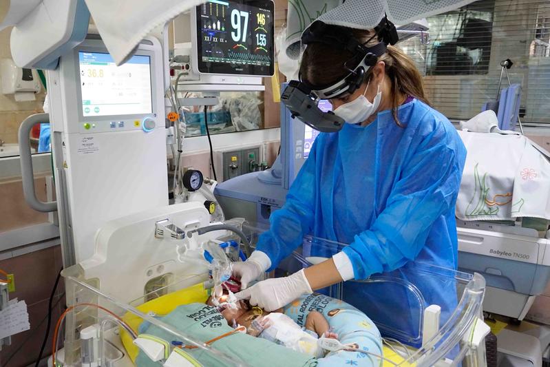 Dr. Ana Lucía Asturias while screening a newborn infant at the Neonatal Dept. of Roosevelt Hospital in Guatemala City