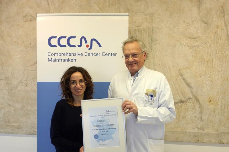 Professor Dr. Ralf Bargou, Direktor des Comprehensive Cancer Center Mainfranken und Mitglied im Direktorium des Bayerischen Zentrums für Krebsforschung, übergibt die Urkunde des BZKF-Young-Scientist-Fellowship-Programms 2025 an Dr. Barbara Altieri. 
