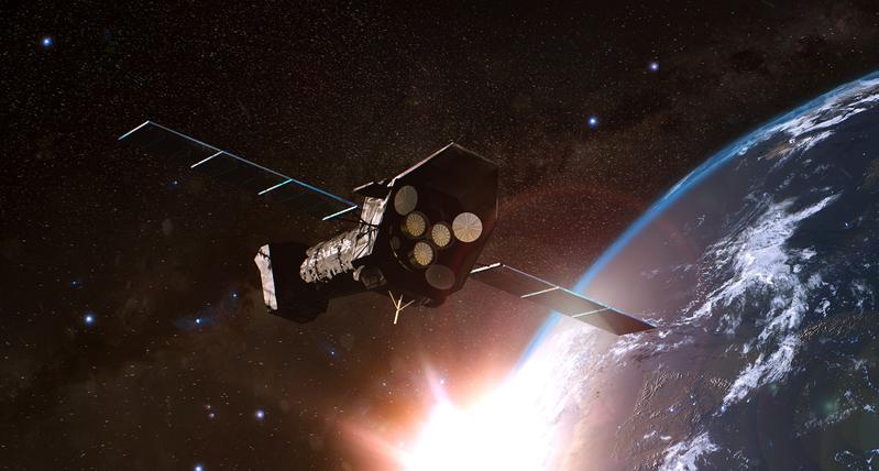 The X-ray satellite XMM-Newton on its orbit around Earth.