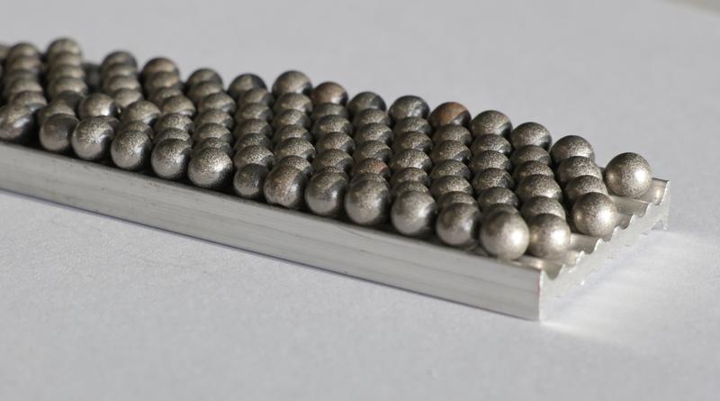 Particle-filled hollow spheres on foamable aluminum.