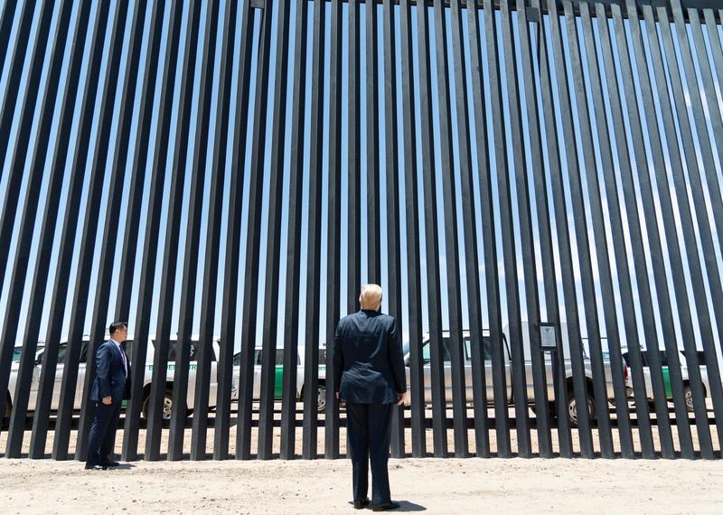 In June 2020, US President Donald Trump views a section of the border wall between Mexico and the United States.