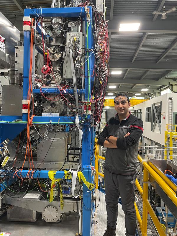 Dr. Ali Mollaebrahimi inspects the MR-TOF-MS setup at TRIUMF in Canada