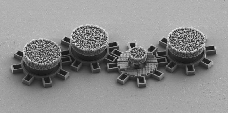 The third gear from the right has an optical metamaterial that react to laserlight and makes the gear move. All gears are made in silica directly on a chip. Each gear is about 0.016 mm in diameter. 