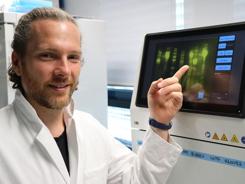 Andrew O’Donnell in front of a gel imaging system