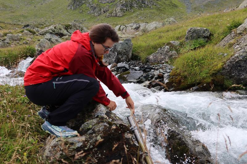 The researcher measures the current water level with a folding rule. 