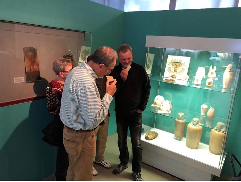 Visitors sniffing the Scent of the Afterlife card during a guided tour at the Museum August Kestner, Hannover, Germany