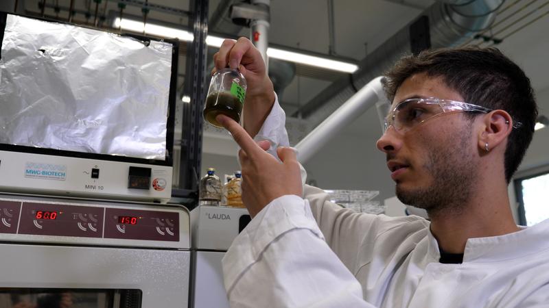 Scientist Tiago Ramalho examines the digestate in the laboratory.