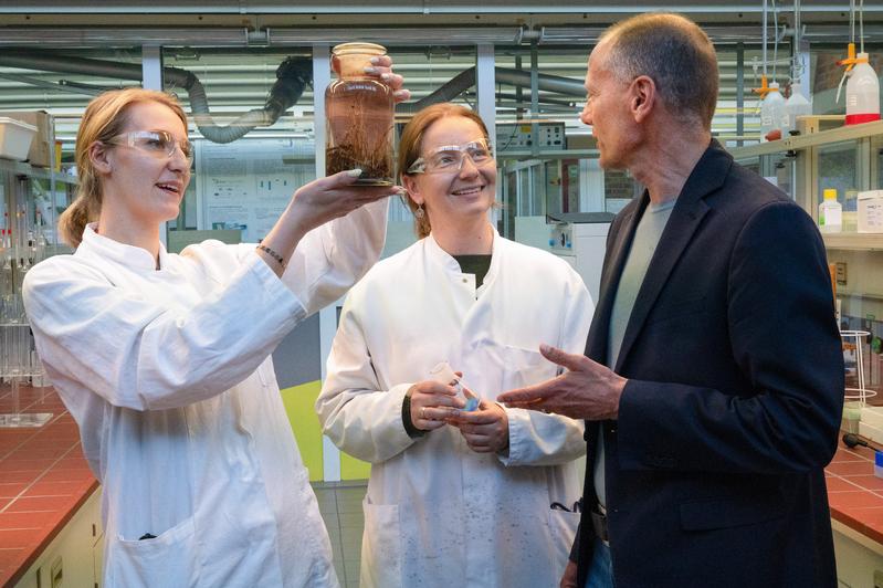 Doktorandin Katharina Bauer und Laboringenieurin Josefine Schlemmer sprechen im Labor mit Hochschulpräsident Prof. Dr. Stefan Gast über die Vorbereitungen für die Lange Nacht der Wissenschaften am 8. Mai. 